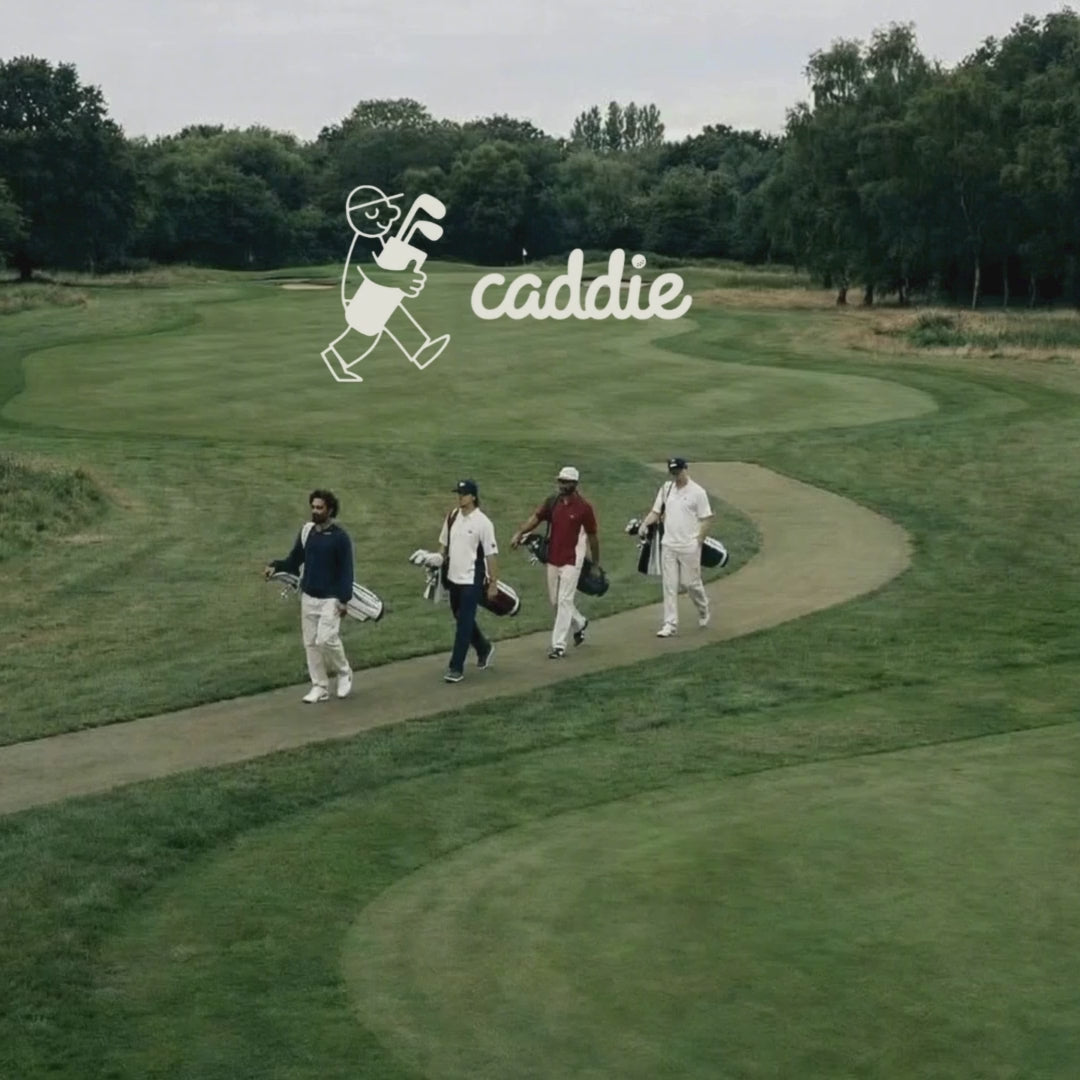 Four golfers walk across the course toward their next shot.”